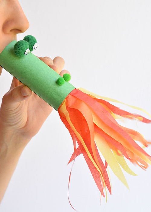 kid playing with fire breathing dragon craft