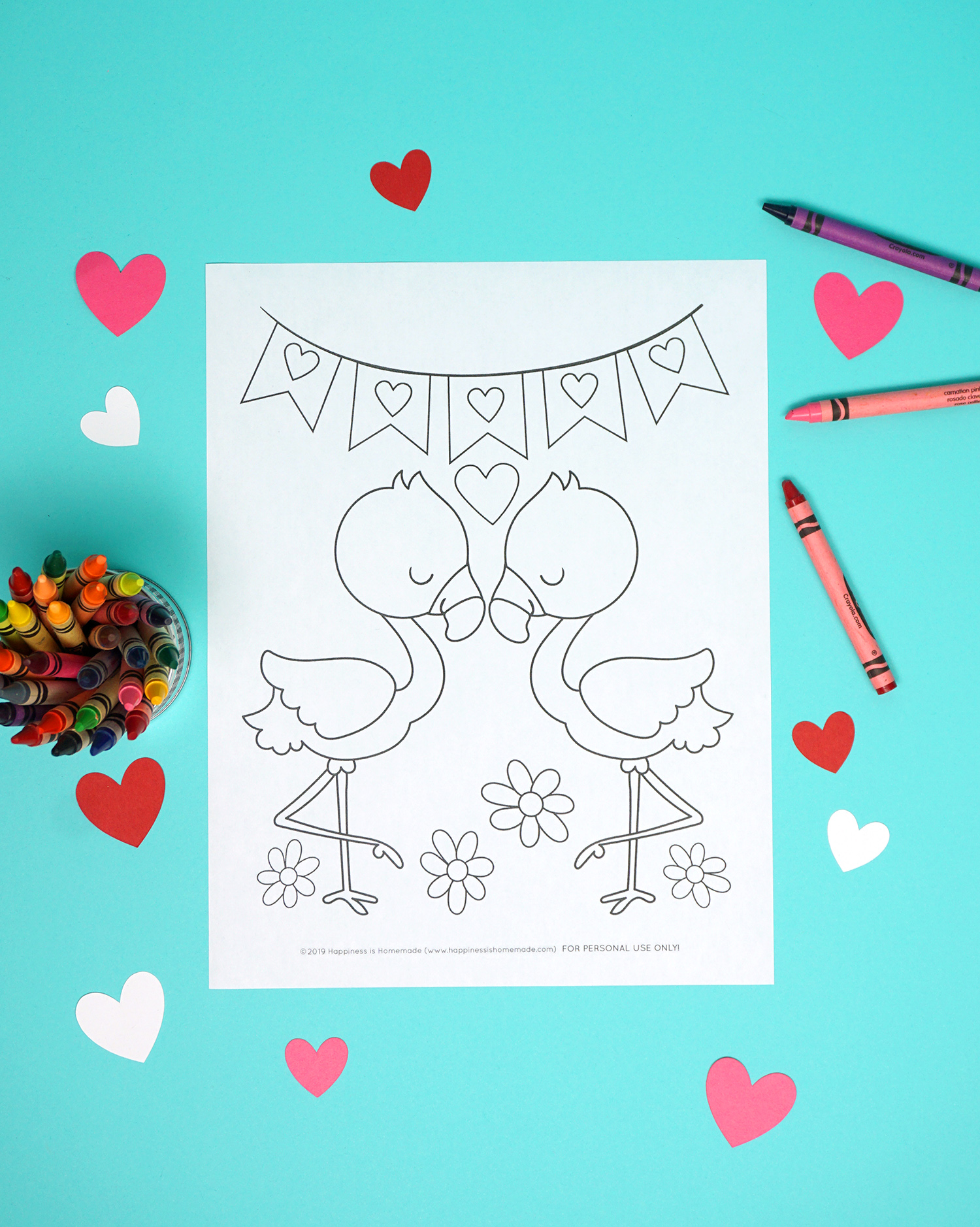 Flamingo coloring page on aqua background with crayons and hearts