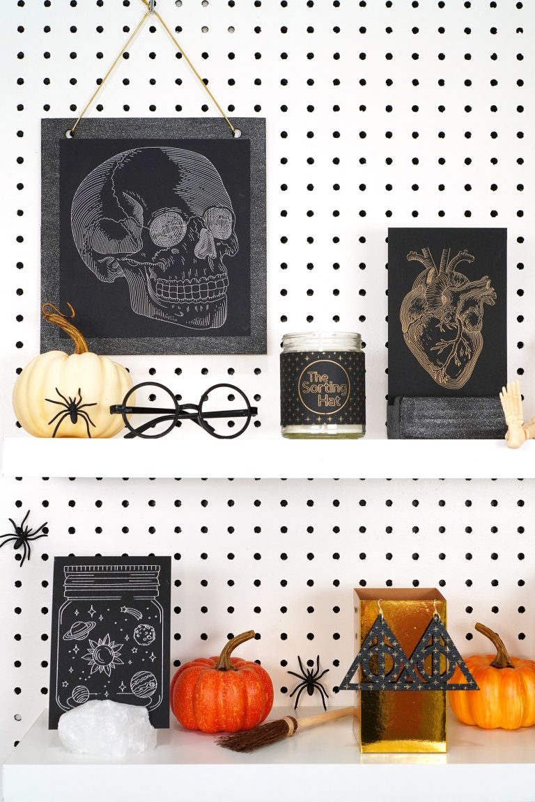 Shelves decorated with Halloween props and Halloween foil art prints