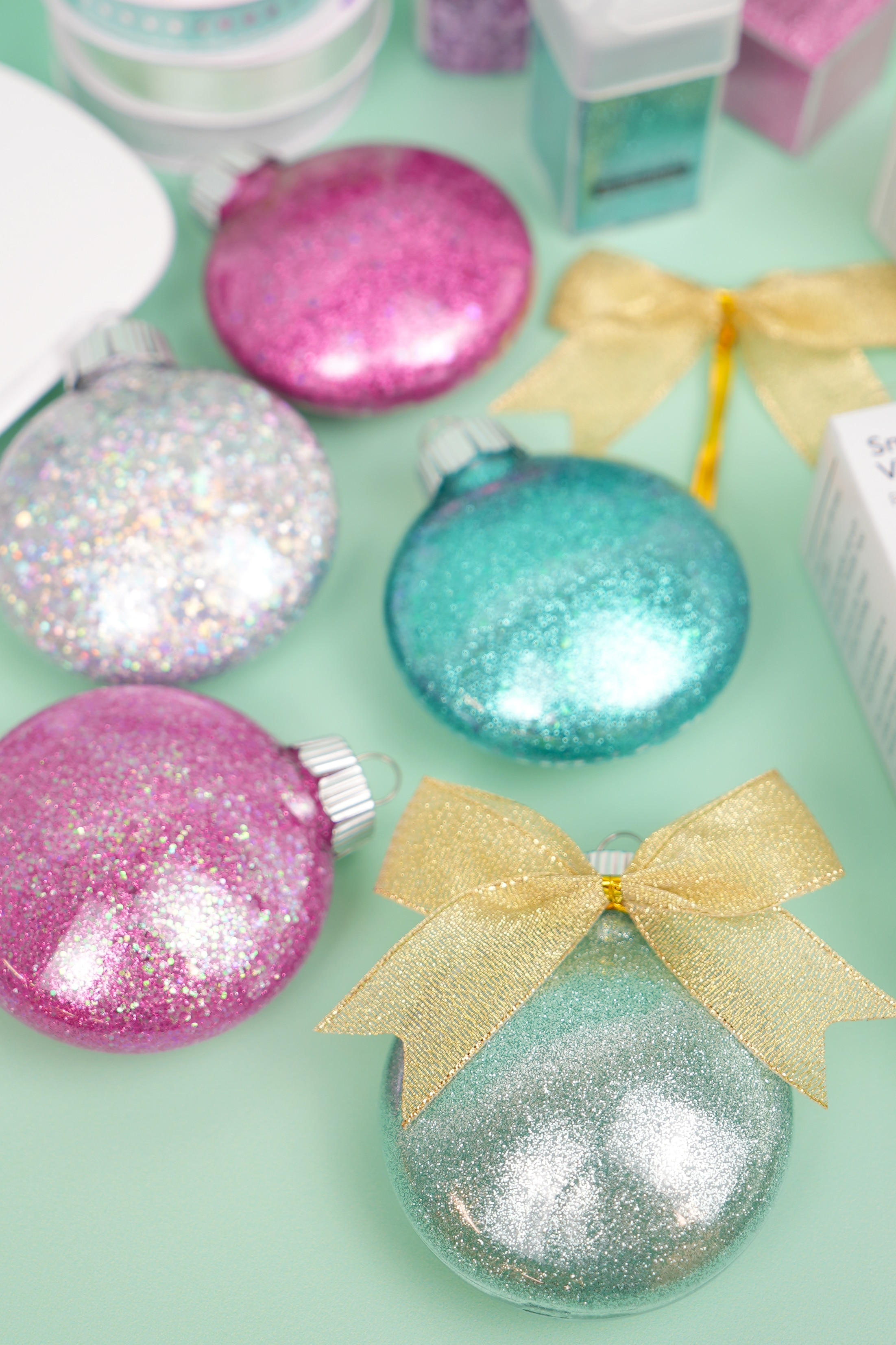 https://www.happinessishomemade.net/wp-content/uploads/2021/12/How-to-Make-DIY-Glitter-Ornaments-with-Bows.jpg