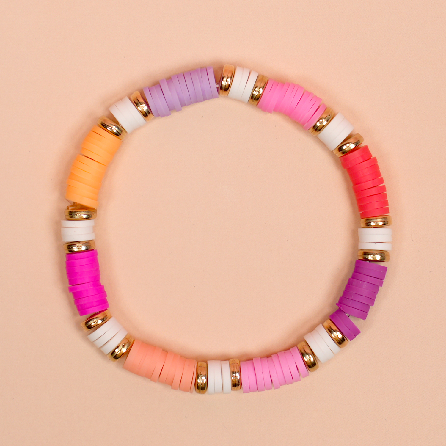Colorful color-blocked heishi clay bead bracelet on peach background