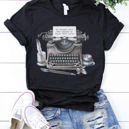 Black t-shirt with typewriter design and "my thoughts have been replaced by Taylor Swift lyrics" text