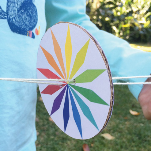 Close up of printable rainbow whirlygig spinner