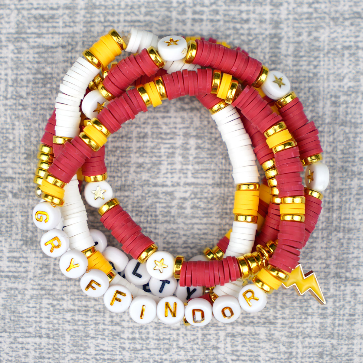 Stack of Harry Potter inspired Gryffindor bracelets on grey background