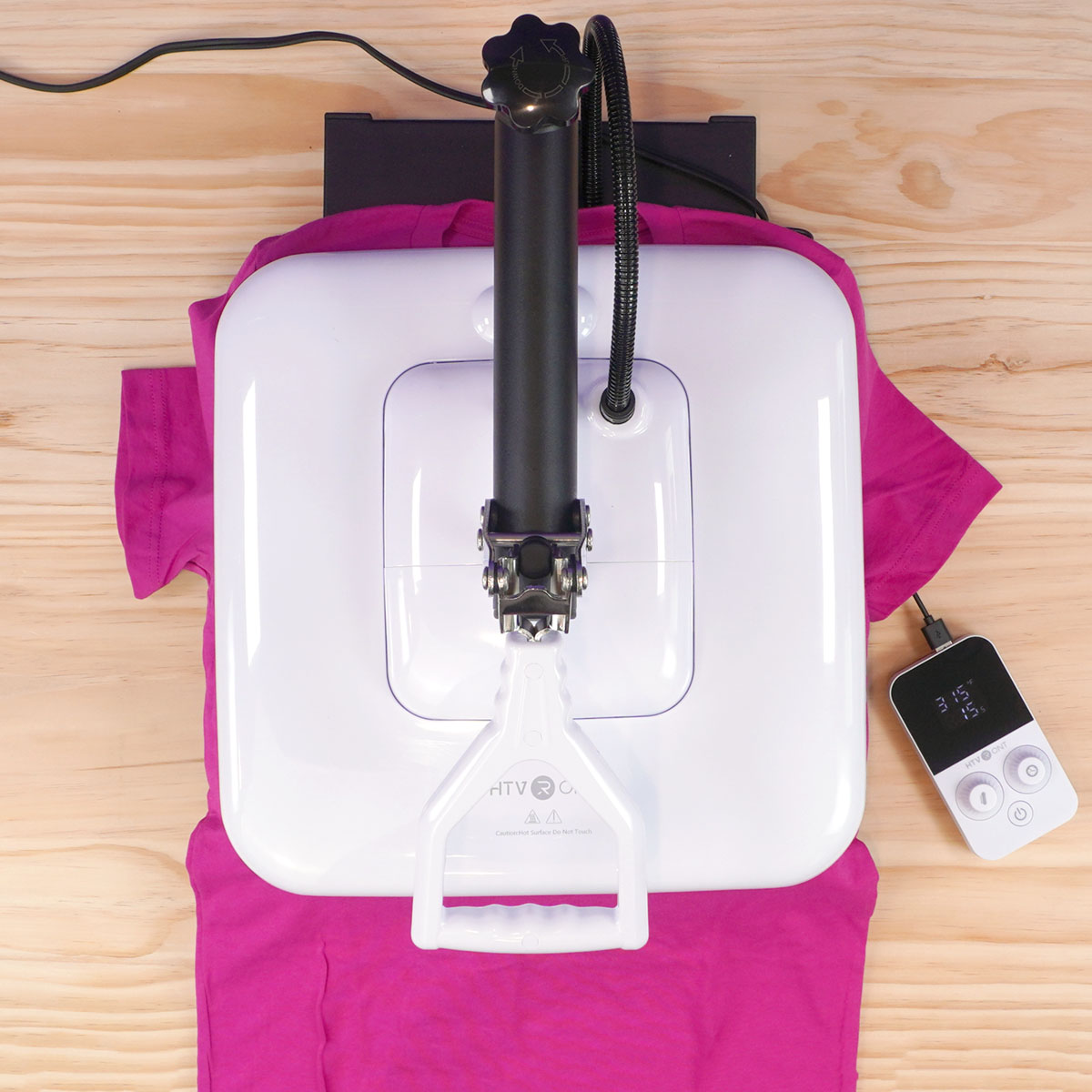 Overhead view of hot pink shirt being pressed in the HTVRONT Manual Heat Press Machine