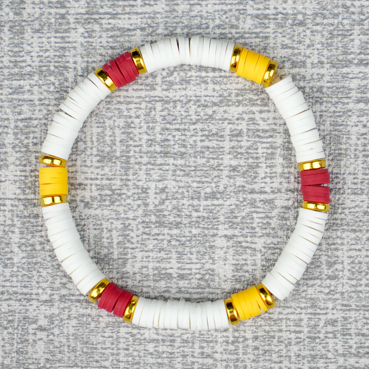 red, yellow, and white Gryffindor house color beaded bracelet on a grey background