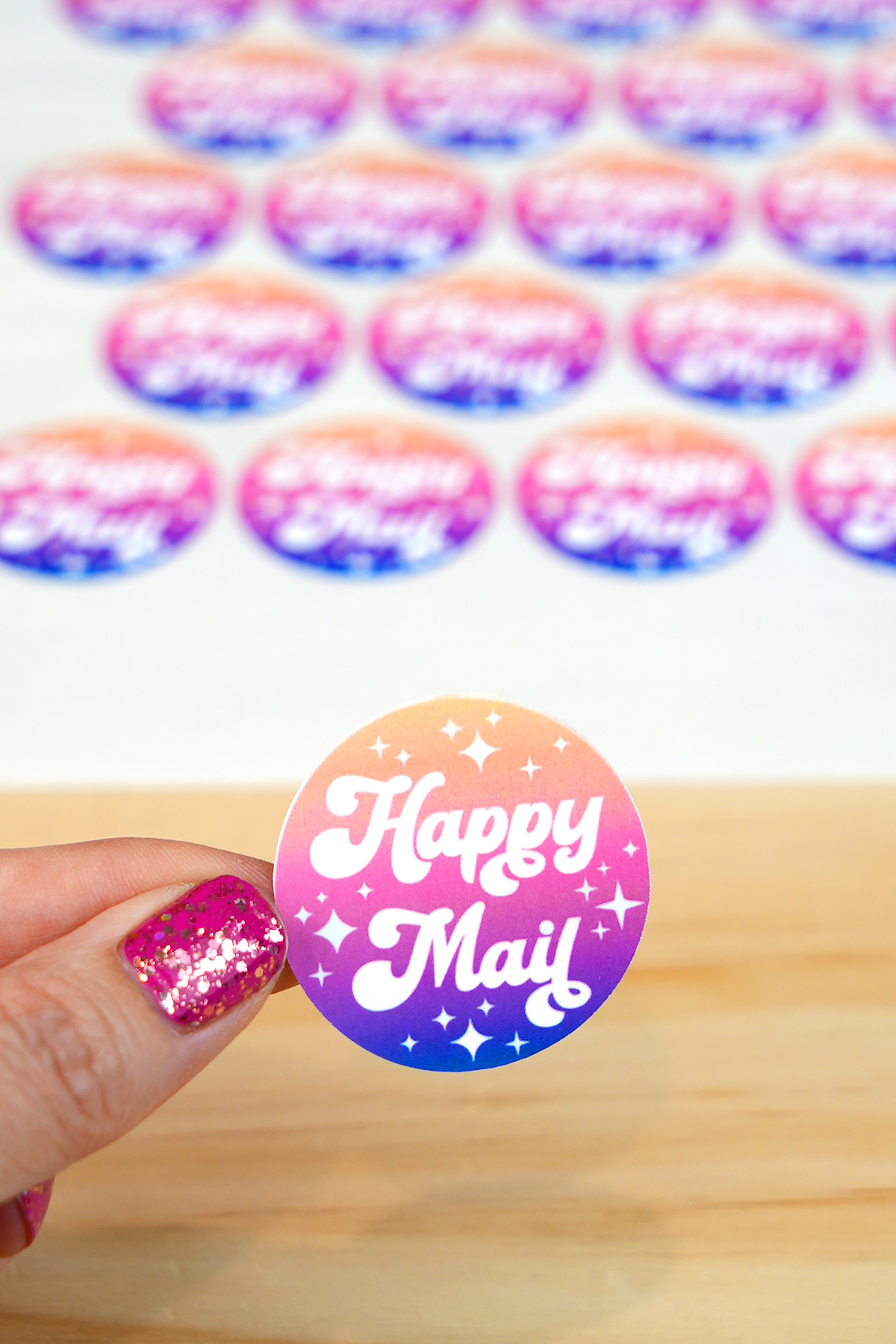 Close up of hand holding single "Happy Mail" sticker peeled from kiss cut sticker sheet